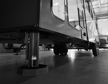 Side view of RV with RV leveling jacks SnapPad